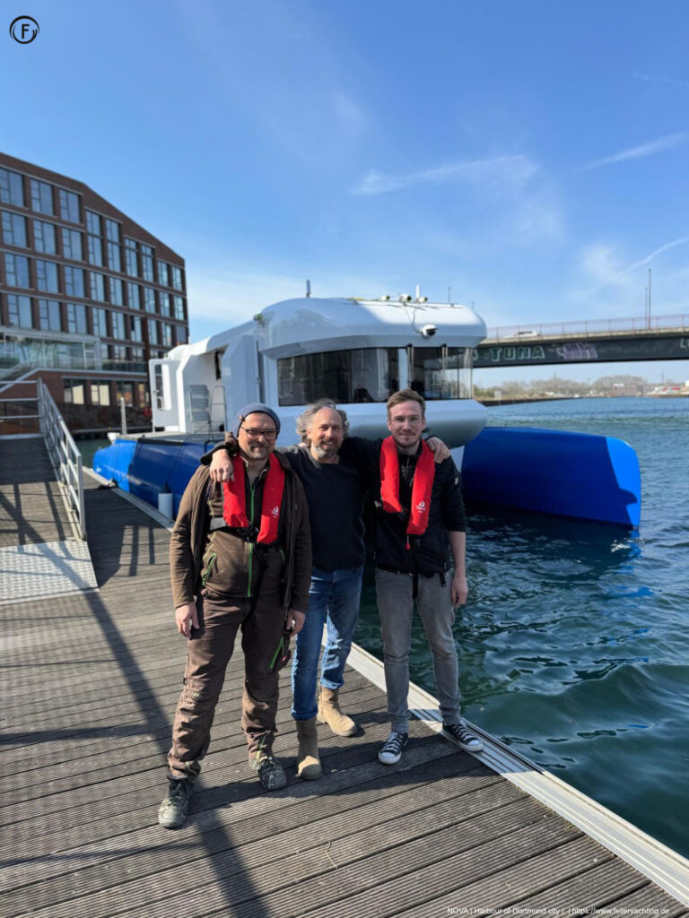 NOVA Visiting the Harbour of Dortmund City, first trials of this fully electric catamaran. In the middle of the three persons, Uwe Feller Designer and Builder.